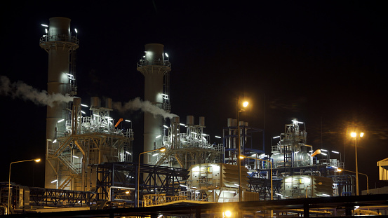Gas turbine electrical power plant at night time for factory energy concept.