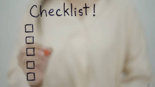 istock Business woman writing plan checklist on glass board in office 1439766730