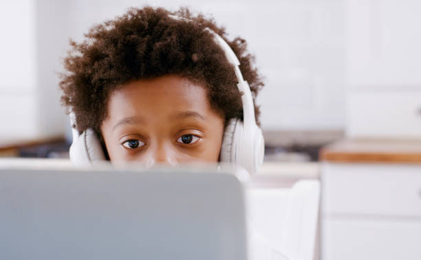 istock Child, laptop and video call online for learning, education or study in home. Boy student, online and computer on video conference for education, communication or school on the internet in a house 1439769220
