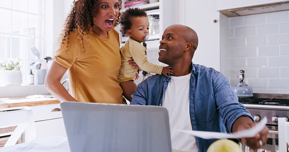 Family, children and finance with a man using a laptop to budget or management investment and savings at home. Computer, ecommerce and documents with an excited woman looking surprised in a house