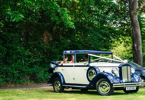 kent, United Kingdom – July 19, 2022: A blue vintage wedding car parked up in the garden in the United Kingdom