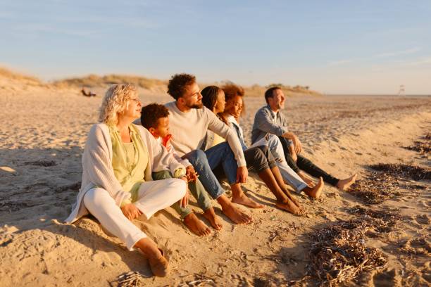istock Multi-generation family enjoying cold sunny day at he beach 1439770883