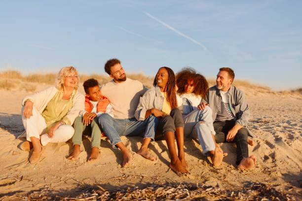 istock Multi-generation family enjoying cold sunny day at he beach 1439770946