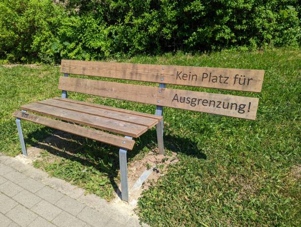 istock Wooden bench with German text saying No place for exclusion! 1439771025