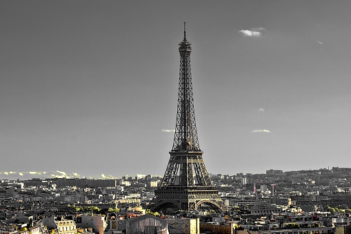 A beautiful shot of the Eiffel Tower during day with a grey sky in the background