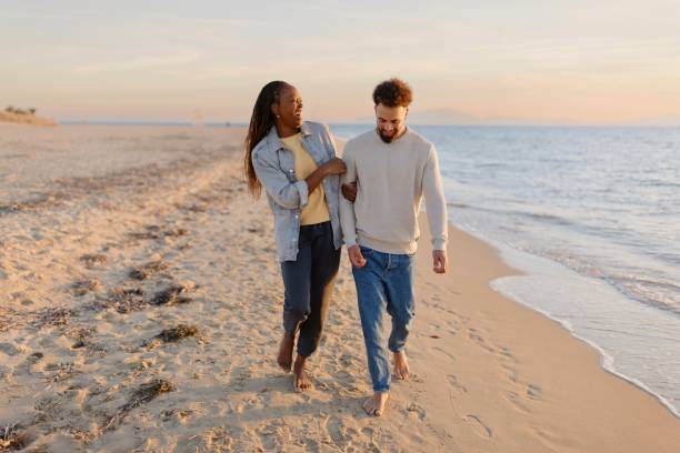istock Couple enjoying walking along the coast. 1439771273