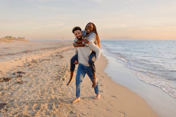 istock Couple enjoying a day at the beach 1439771285