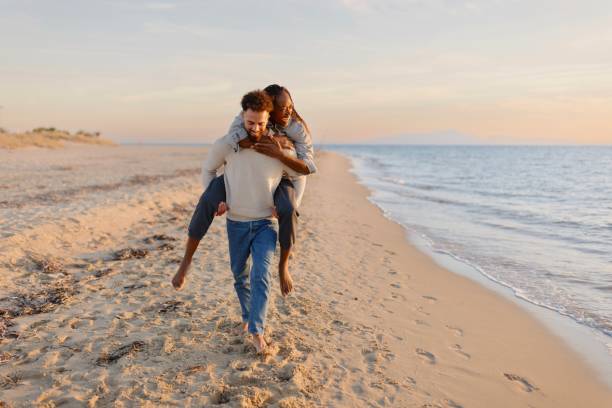 istock Couple enjoying a day at the beach 1439771316