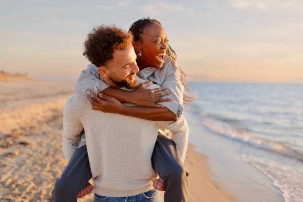 istock Couple enjoying a day at the beach 1439771438