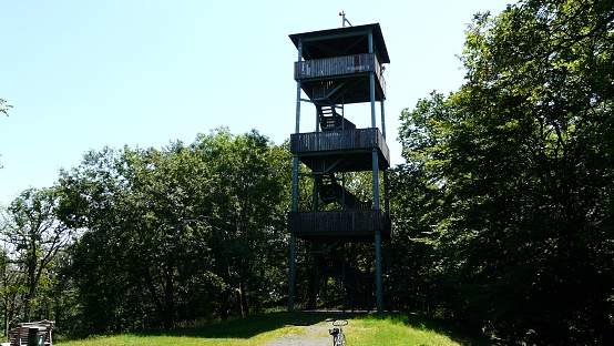 35075 Gladenbach, Germany – July 20, 2022: An abandoned observation tower with trees and skyline