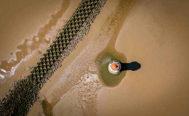 istock Aerial view of a lighthouse on the sandy shore 1439772913