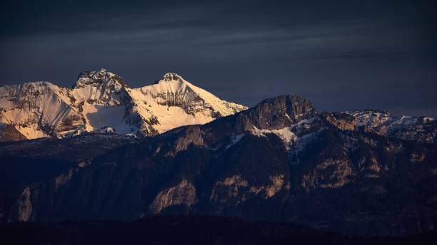 istock View of rocky mountains covered with snow during sunset 1439773941