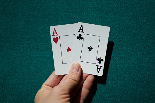 A closeup shot of playing cards held in a human hand