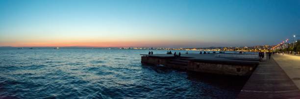istock Sunset over the blue water next to the city 1439775504