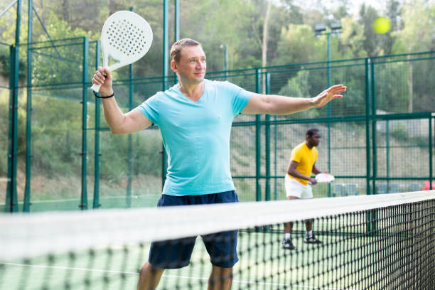 istock Man playing padel tennis on court 1439776220