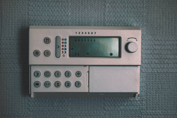 istock a heating controller isolated. an old thermostat on a wall. cinematic look 1439776451