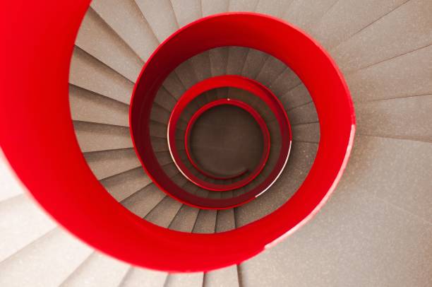 istock High angle shot of a winding staircase with a red railing 1439776725