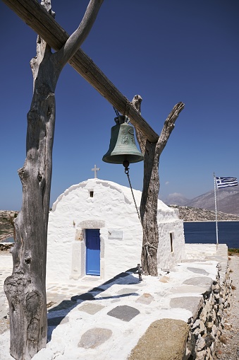 A vertical shot of a bell near Panagia Church, Nikouria, Amorgos island under blue night