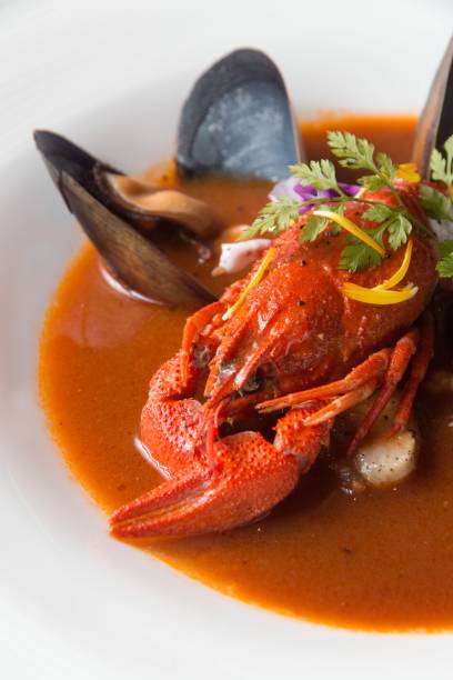 istock Savory lobster with calms soup on a white bowl 1439778310