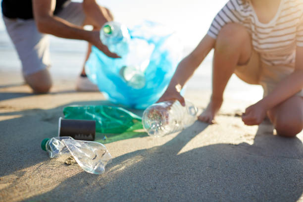 istock Father and son cleaning beach together 1439778700