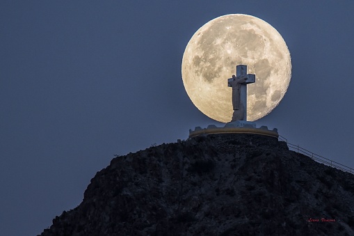 A beautiful shot of Mount Cristo Rey, with a large full moon in the background