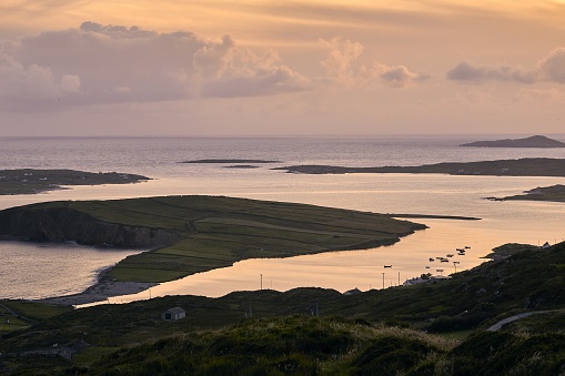 A landscape of the Sky Road surrounded by the sea during the sunset in Clifden in Ireland