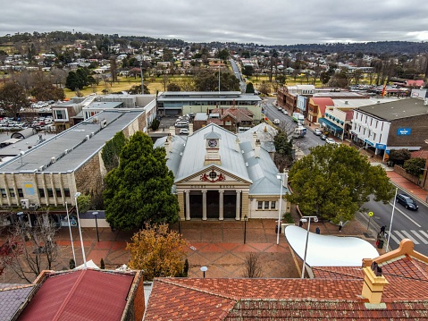 Armidale, Australia – July 13, 2022: An aerial view of Armidale Court House and traffic on roads on a cloudy day