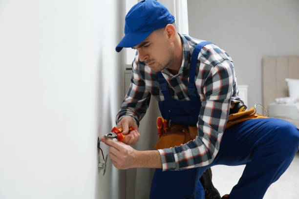 istock Electrician with pliers repairing power socket indoors 1439781407