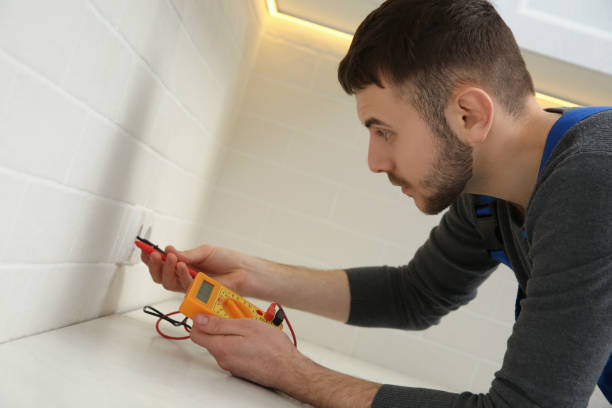 istock Professional electrician with tester checking voltage indoors 1439781490