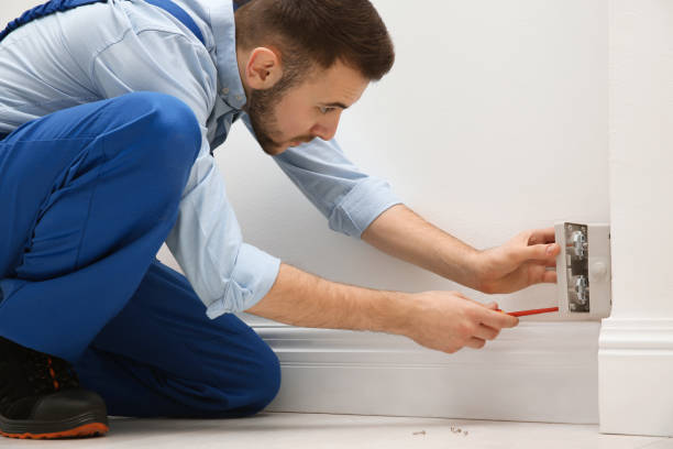 istock Electrician with screwdriver repairing power socket indoors 1439781690