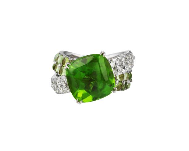istock Precious ring with a green gemstone under the lights isolated on a white background 1439781910