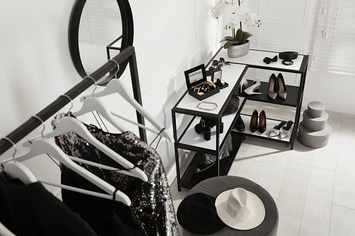 Shelving unit with stylish women's shoes, clothes and accessories in dressing room, above view