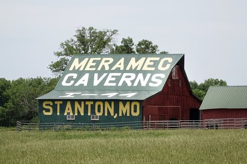 Cuba, United States – July 06, 2018: photo of a colorful barn in Missouri with an advertisement for Meramec Caverns painted on it