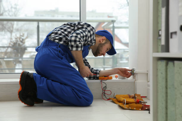 Electrician with screwdriver repairing power socket indoors Electrician with screwdriver repairing power socket indoors handyman stock pictures, royalty-free photos & images