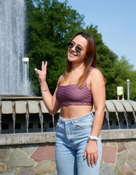 A beautiful Hispanic girl in purple top posing for picture