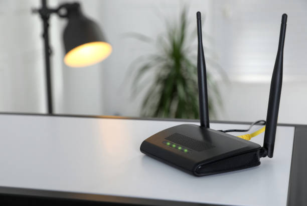 istock Modern Wi-Fi router on table indoors. Space for text 1439782621