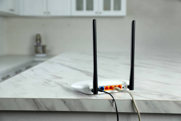 istock Modern Wi-Fi router on white marble table in kitchen 1439782635