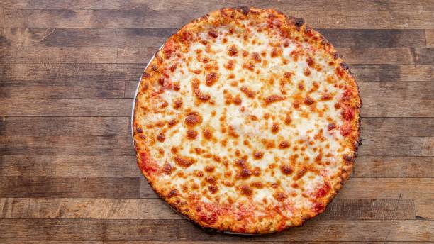 A homemade cheese pizza sits atop a decorative cutting board.