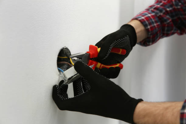 istock Electrician with pliers repairing power socket, closeup 1439783084