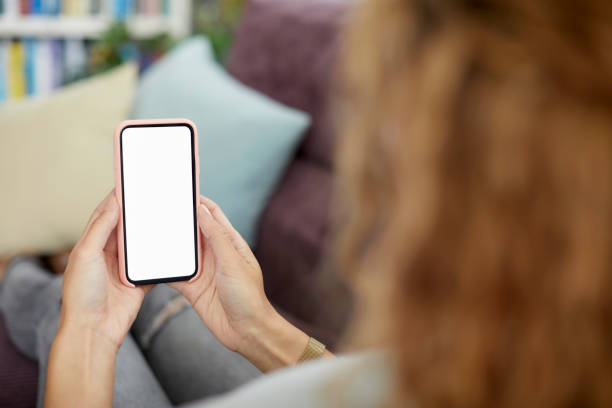 istock Female holding mobile phone with blank screen 1439783556