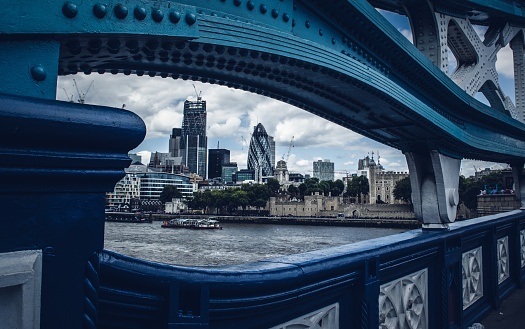 A view of the 30 St Mary Axe from a bridge on the river surrounded by buildings in London, England