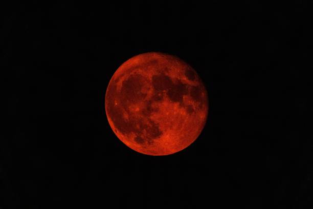 istock Full moon in the dark black sky at night 1439784498