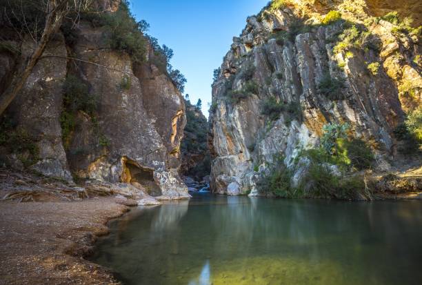 istock Beautiful river surrounded by tree-covered rocky cliffs captured in Chelva, Valencia, Spain 1439786680