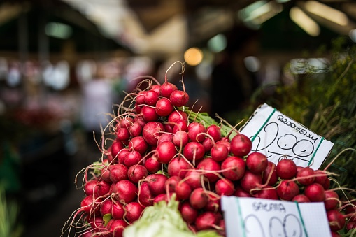 A selective focus shot of a stack of delicious healthy reddish in the middle of the market