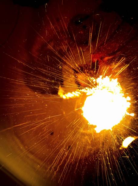 istock Vertical shot of bright yellow sparks on a blurred background 1439787821