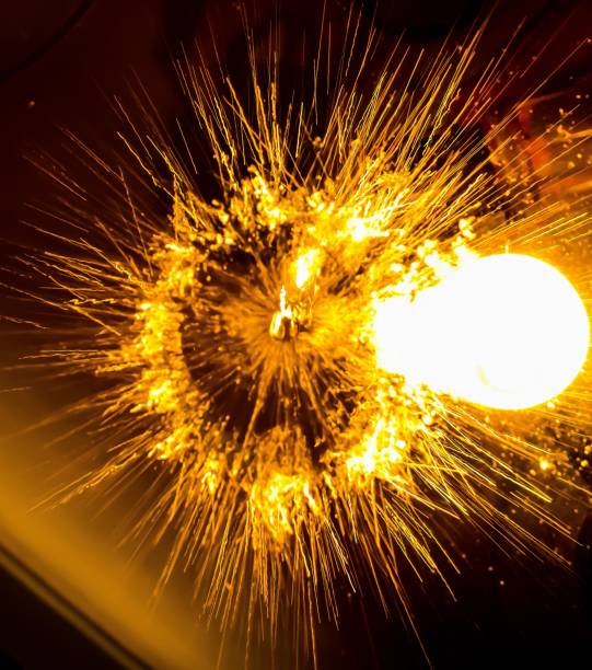 istock Vertical shot of bright yellow sparks on a blurred background 1439787822