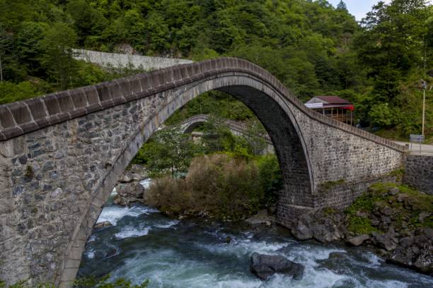 istock Arch bridge above a river surrounded by forests in Arhavi in Turkey 1439787939