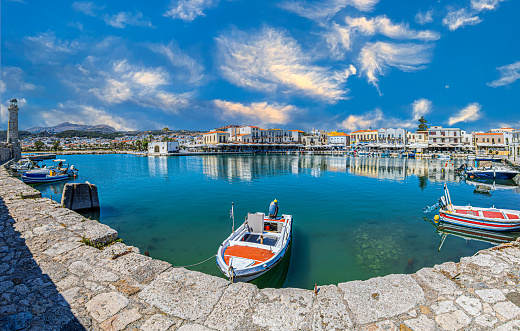 Rethymno, Crete island: The old harbour built by the Venetians in the 13th century, with the Egyptian lighthouse, small fishing boats and yachts, restaurants, taverns, bars and cafes.