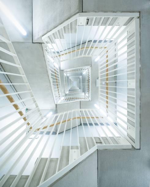 istock Vertical top view of rectangular staircase with white and orange railings 1439789498
