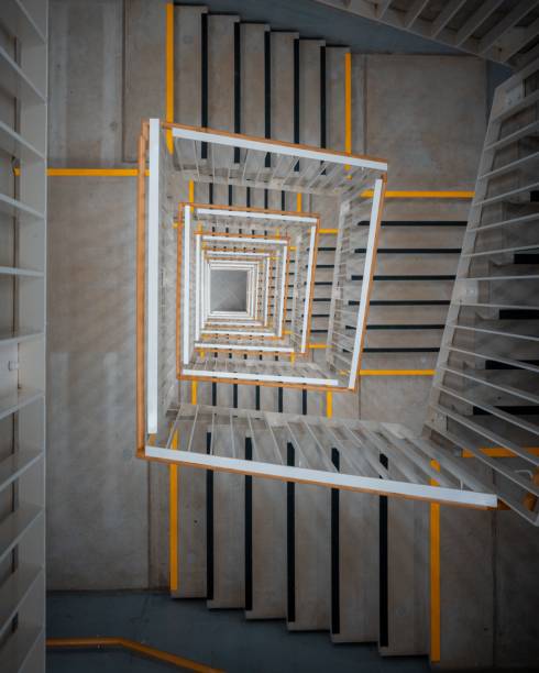 Staircase in a spirlal form. The image shows a modern staurcase illuminated by some electric lamps.